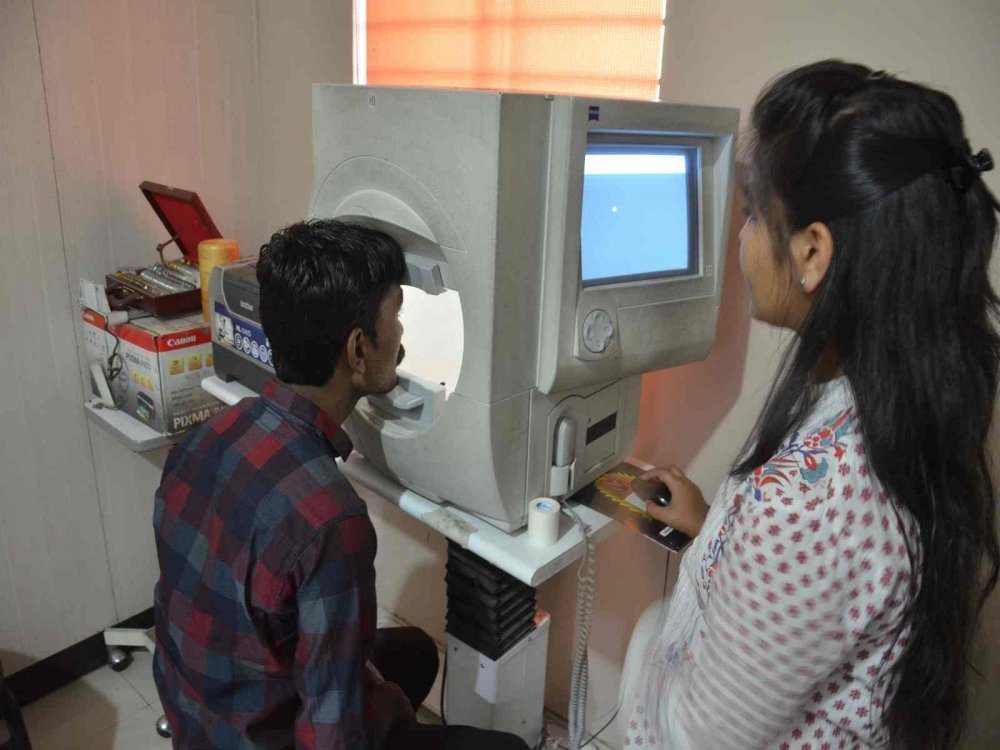 Patient using eye diagnostic equipment